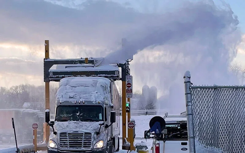 Schneider YETI auger and blower system breaking up and discharging snow from a commercial vehicle